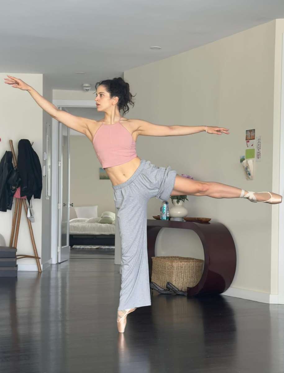 Rosalía practices an elegant arabesque en pointe as she continues exploring the world of classical ballet.