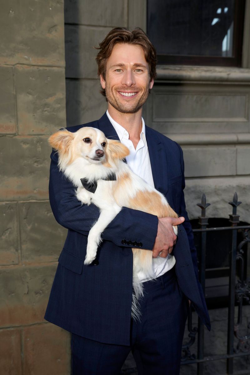 Glen Powell attends Charlize Theron's Africa Outreach Project (CTAOP) Block Party with his dog