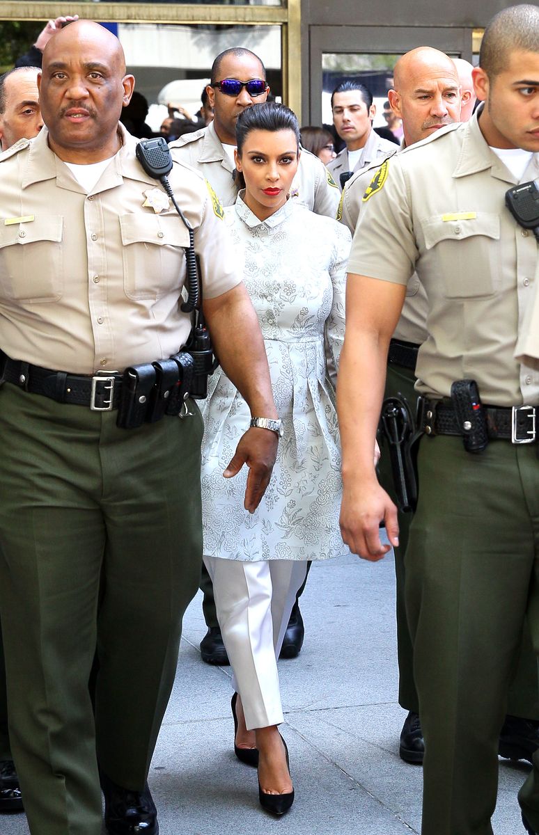 Kim Kardashian surrounded by Los Angeles County Sheriff Deputies leaves the Stanley Mosk Courthouse after attending her divorce hearing from Kris Humphries on April 12, 2013 in Los Angeles, California.