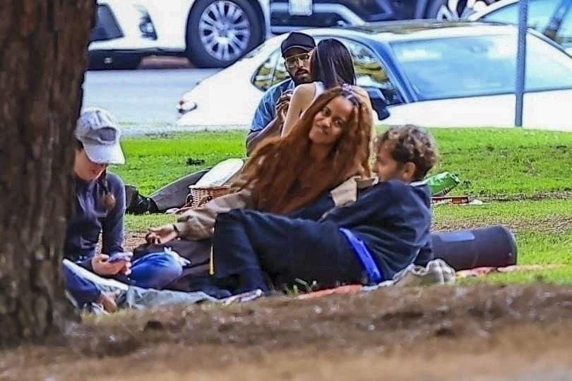  The group enjoyed an afternoon outing under a shady tree where a few others came and joined them. Malia could be seen with a large cooler that she bought along with snacks and drinks.