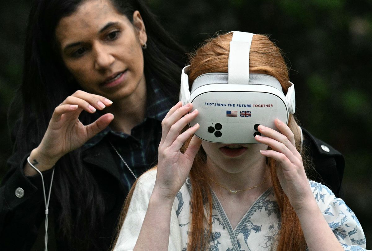 A young girl takes part in a youth activity with US First Lady Melania Trump and Britain's Queen Camilla.