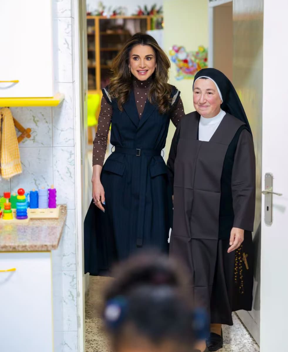 Queen Rania wore a vest by Japanese brand Sacai over a chocolate-brown high-neck top with crystal details by Paco Rabanne, paired with rounded-toe leather ankle boots from Jacquemus.