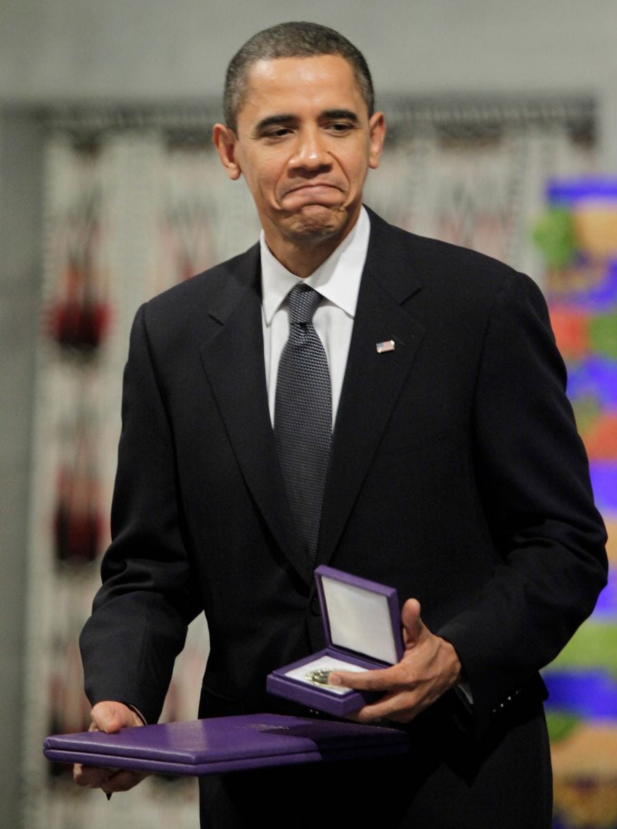 Nobel Peace Prize laureate, US President Barack Obama poses with his diploma and medal during the Nobel Peace prize award ceremony at the City Hall in Oslo on December 10, 2009. 