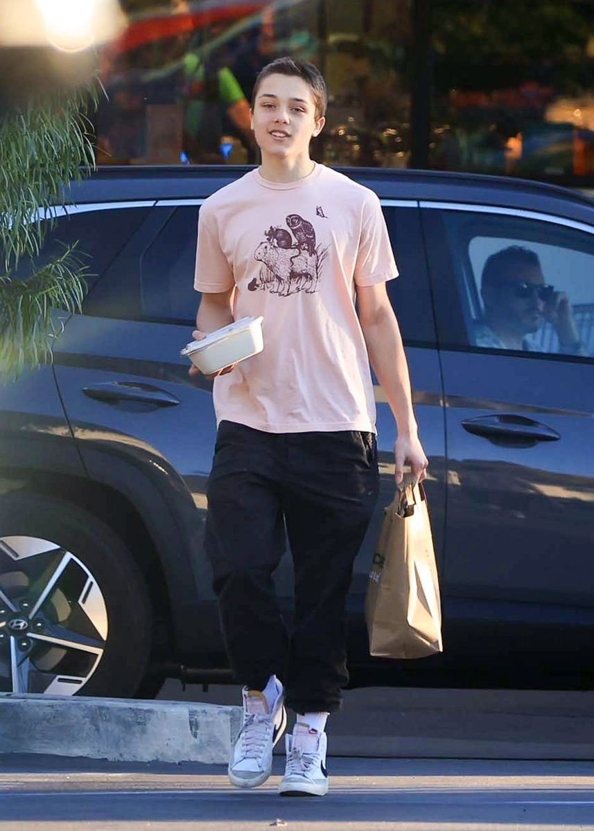 Knox wore a pink graphic tee that he paired with black pants and sneakers