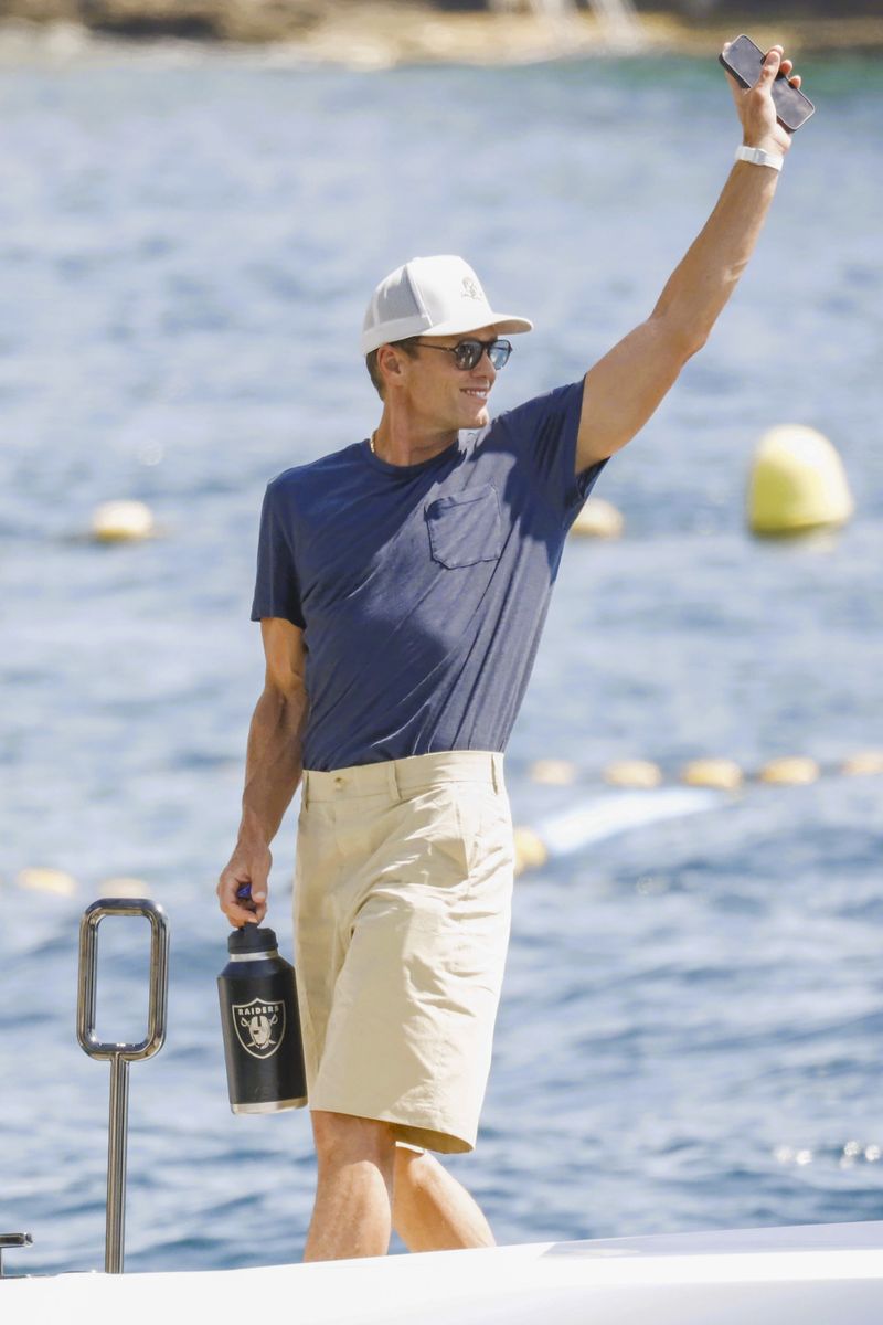Brady kept it casual in a navy T-shirt, cream shorts and white sneakers