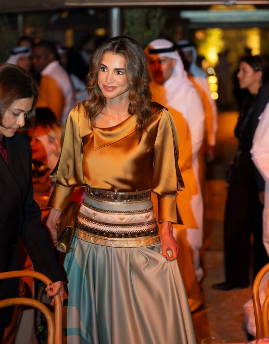 Queen Rania completed her look with sharp-toed gold pumps, a matching clutch, and oversized earrings.