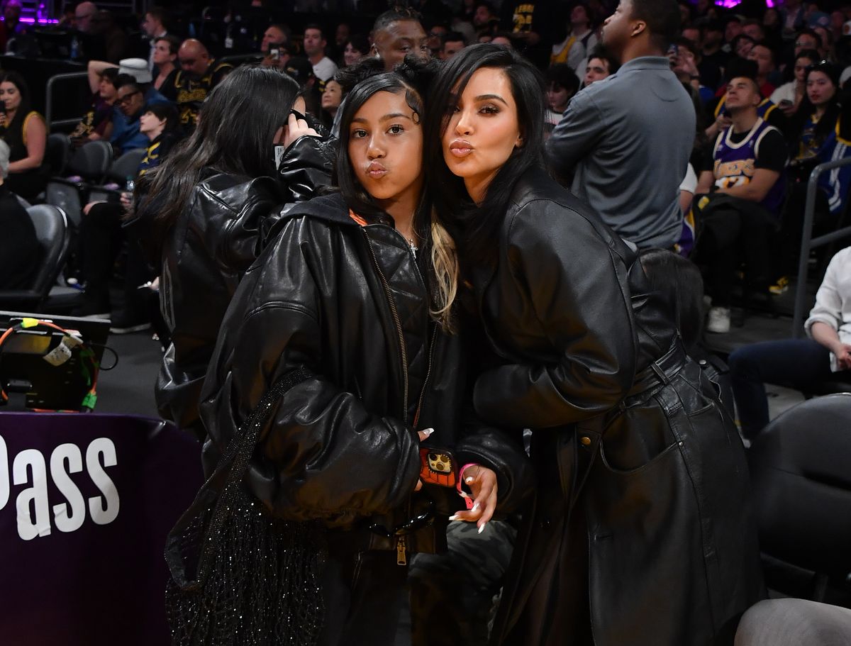 Kim Kardashian (R) and North West attend a basketball game between the Los Angeles Lakers and the Golden State Warriors at Crypto.com Arena on April 09, 2024 in Los Angeles, California.