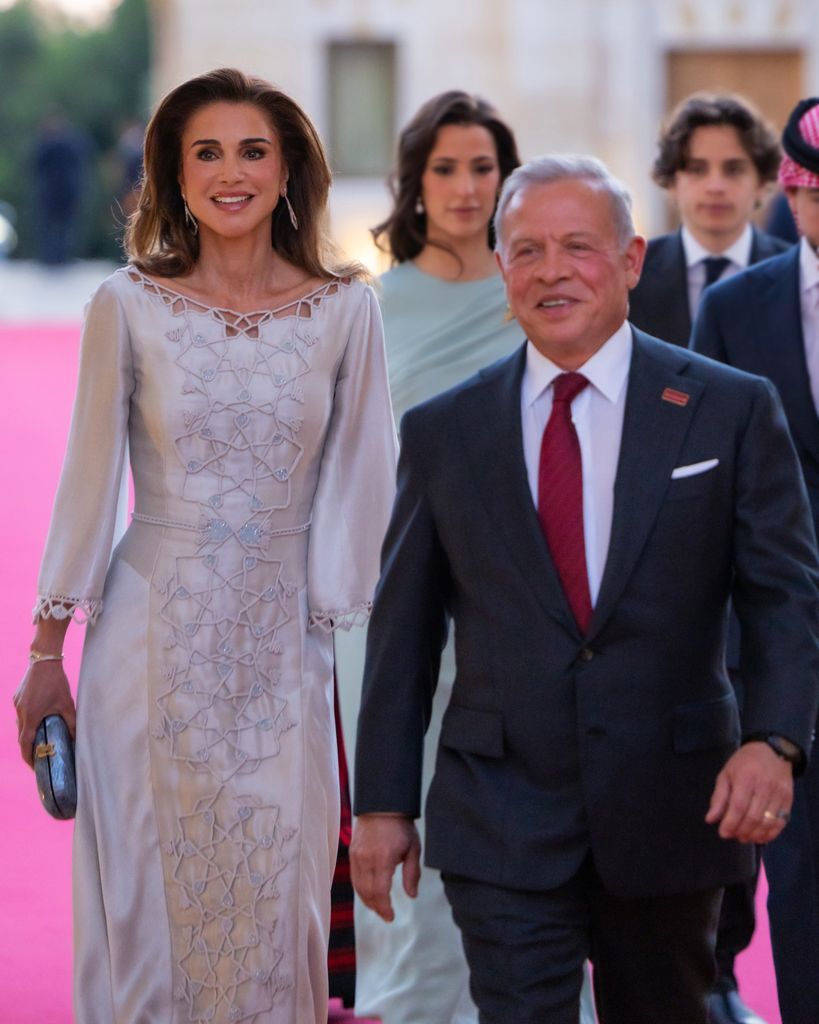 King Abdullah and Queen Rania share a joyful moment with their children at the reception following the ceremony.