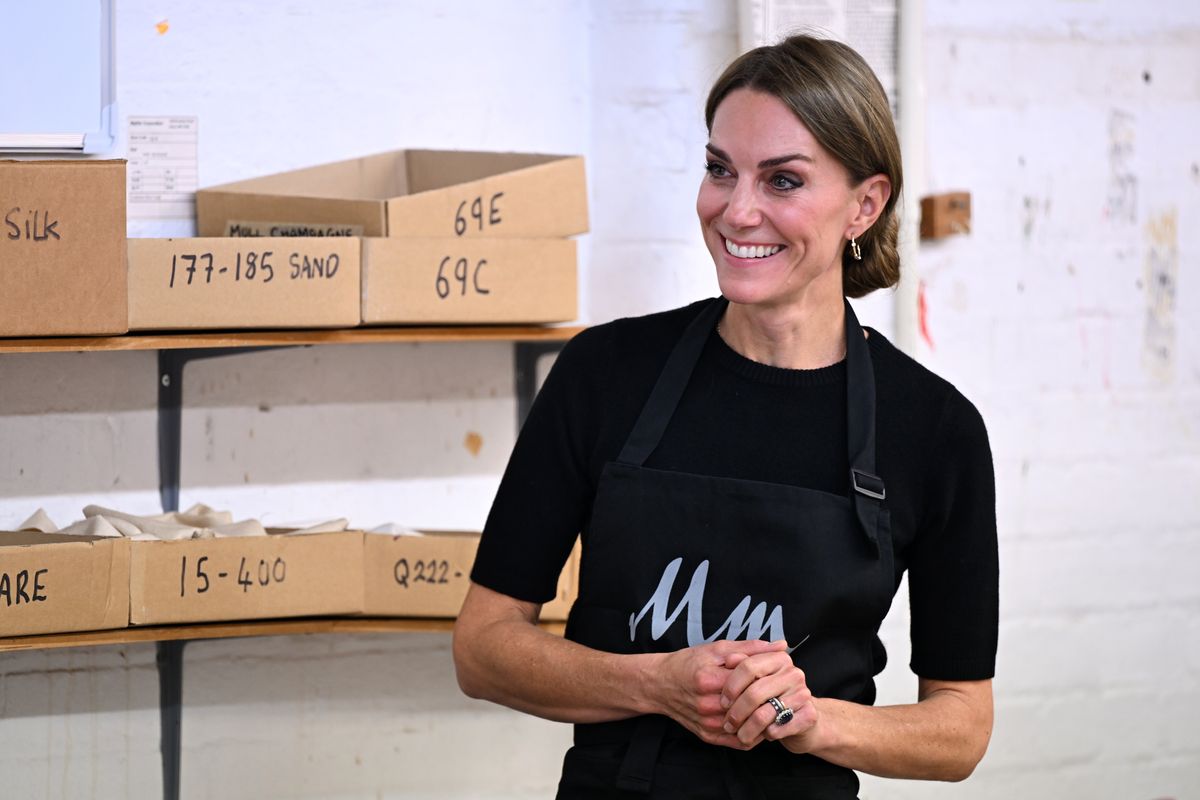 CUXTON, ENGLAND - SEPTEMBER 11: Catherine, Princess of Wales smiles as she creates a screen print during a visit to Marina Mill on September 11, 2025 in Cuxton, England.  Marina Mill was established in 1967, and is based in an old Victorian mill on the banks of the River Medway, where a small team produces fabrics using the traditional silk-screen method. (Photo by Chris J Ratcliffe - WPA Pool/Getty Images)