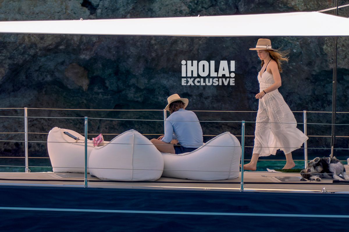 Joined by Ana de Armas’ pack of dogs, they enjoyed the calm Mediterranean waters together. Ana, glowing in a classic Ibizan-style dress, battled the breeze as she got ready to read Annie Bot, the trending novel by Sierra Greer. One of her dogs, Salsa, lounged on deck watching the interaction between Ana and Tom. They've been discreet—even when the British press went wild after they both showed up at Beckham’s 50th birthday in April—but the chemistry between them is undeniable.