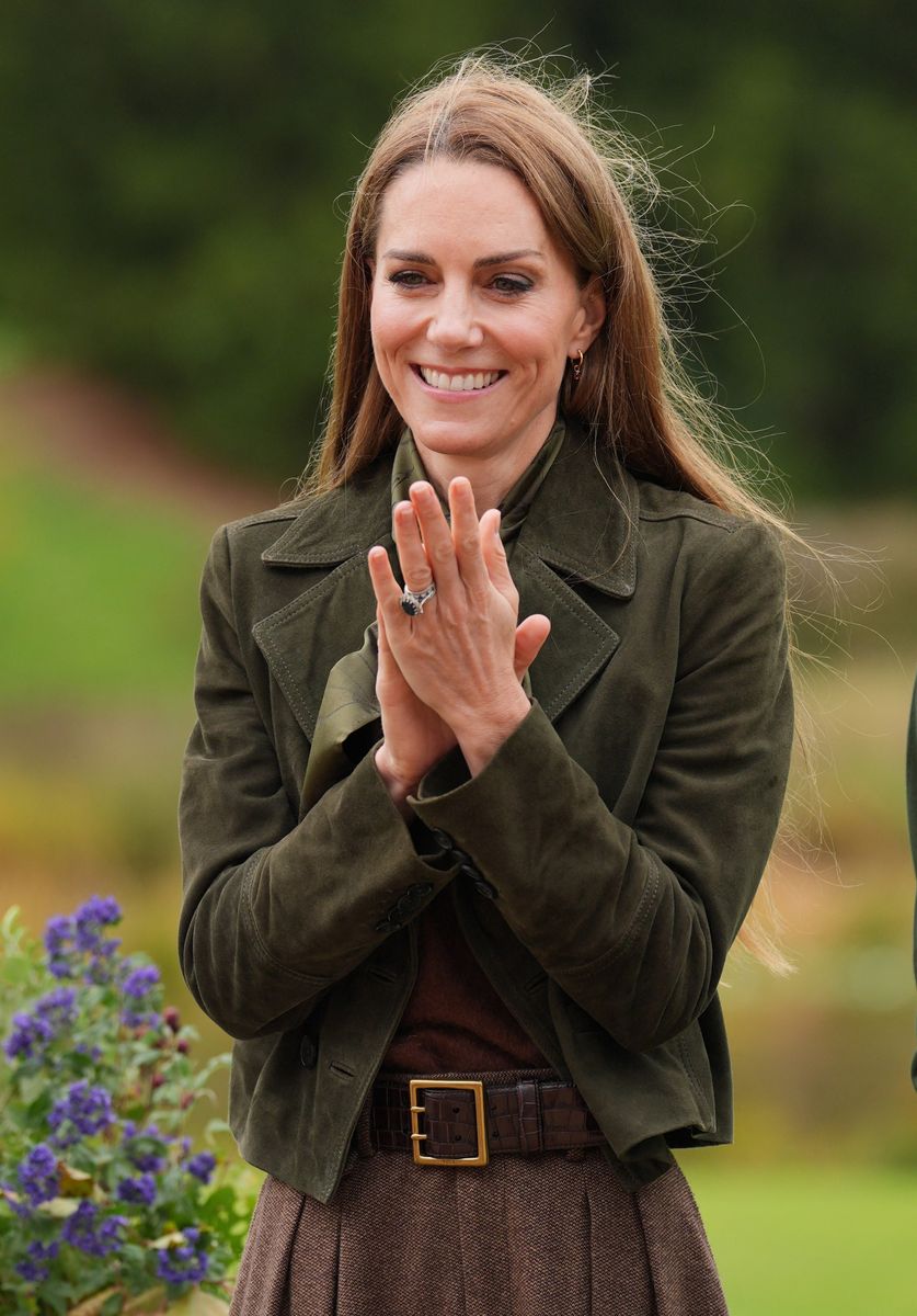 Kate Middleton opted for an earthy color palette, pairing an olive-green jacket with a brown skirt and matching belt during an outdoor engagement at Windsor's Frogmore Cottage.
