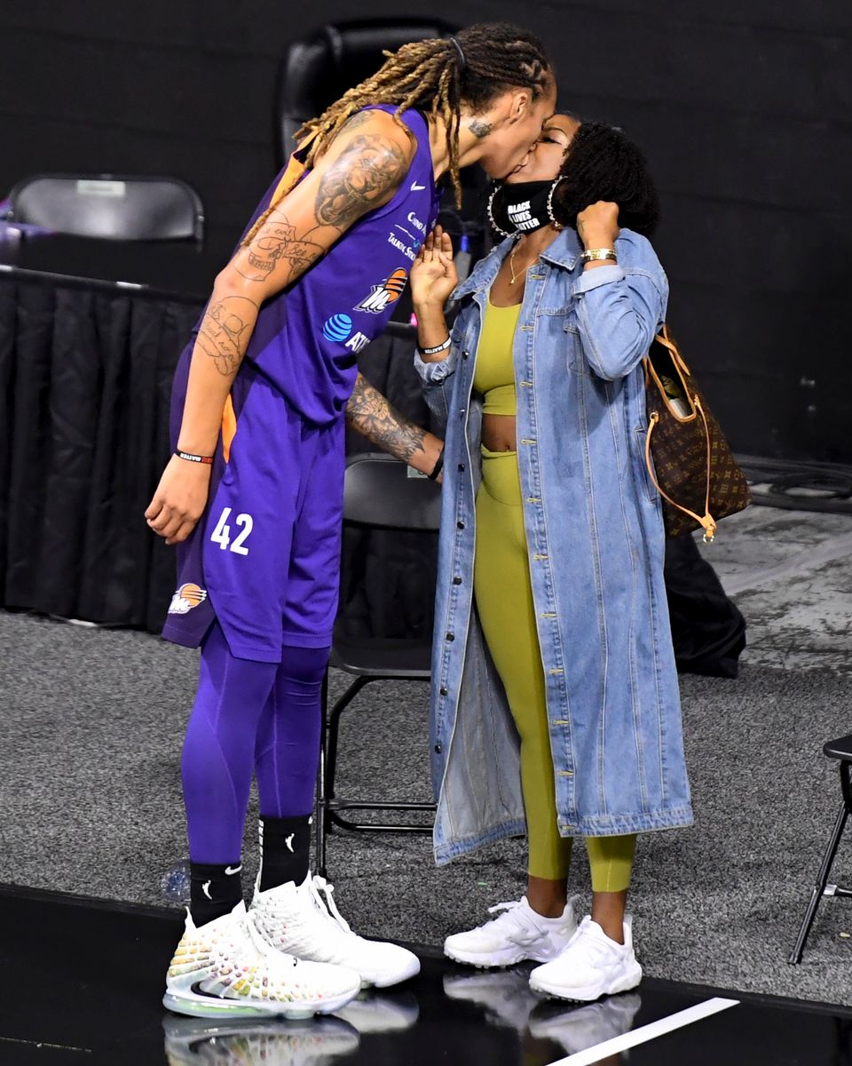 Brittney Griner #42 of the Phoenix Mercury kisses wife Cherelle Watson