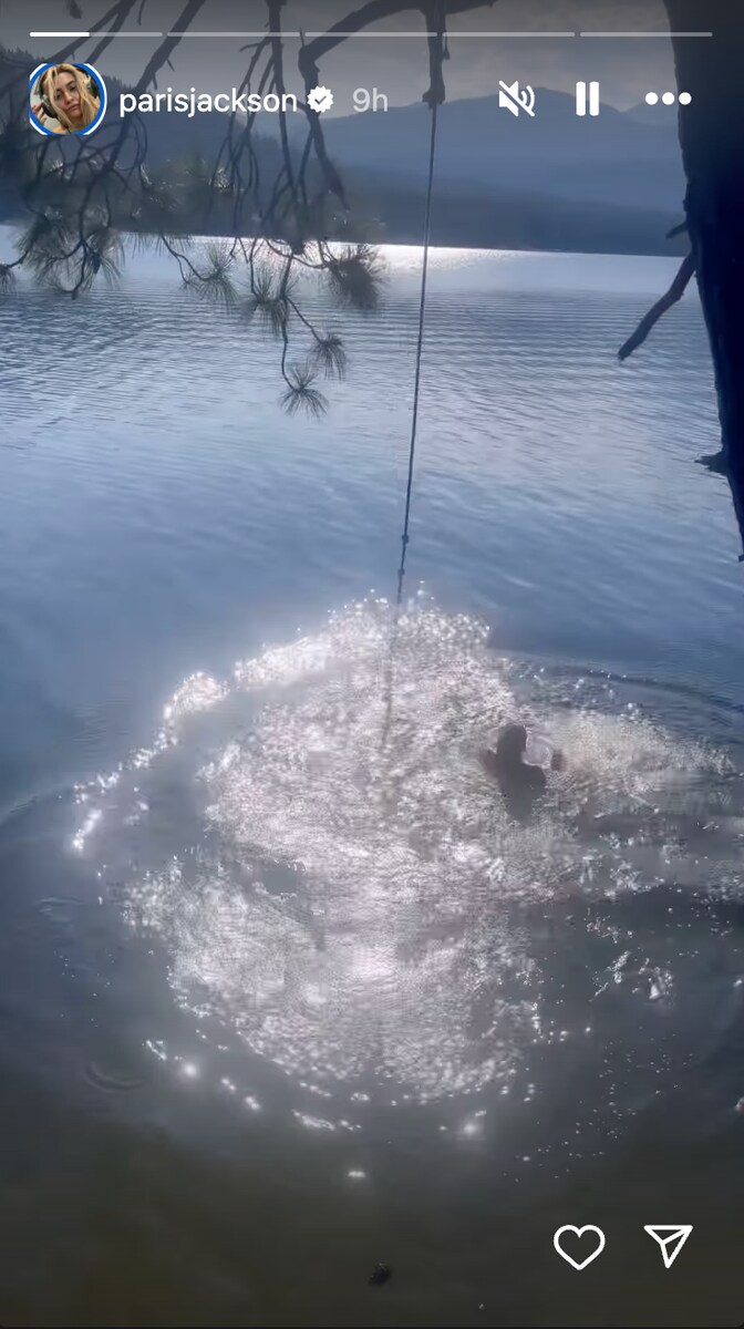 Another photo shows Paris standing waist-deep in the lake.
