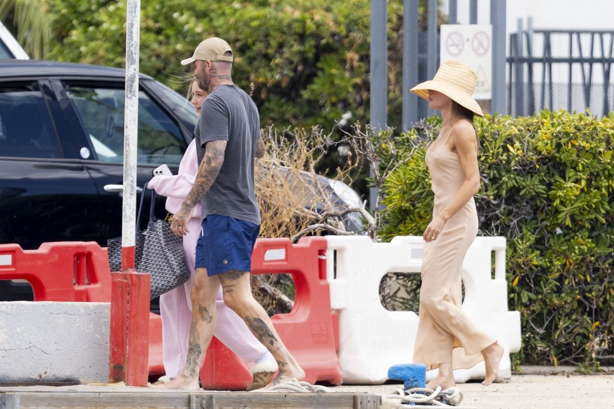 David was seen embracing his 14-year-old daughter Harper as they boarded a speedboat to head to shore. 