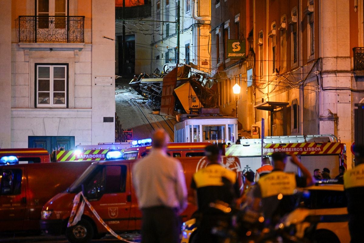 Firefighters and police officers work the scene at Gloria funicular derail site 