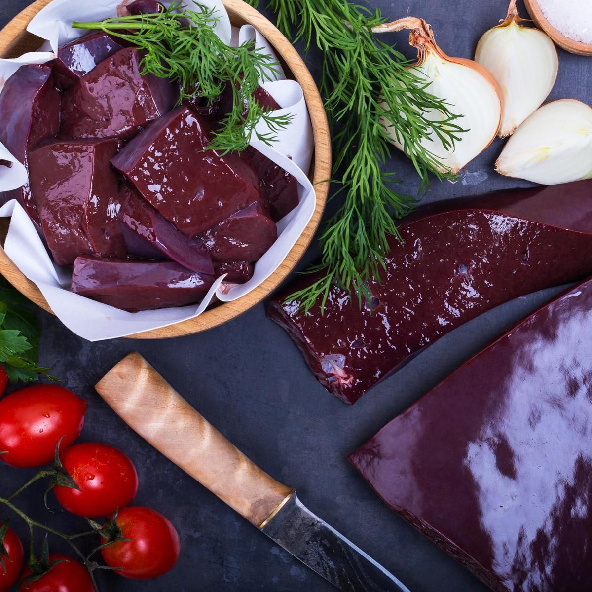 Raw beef liver over gray background viewed from above