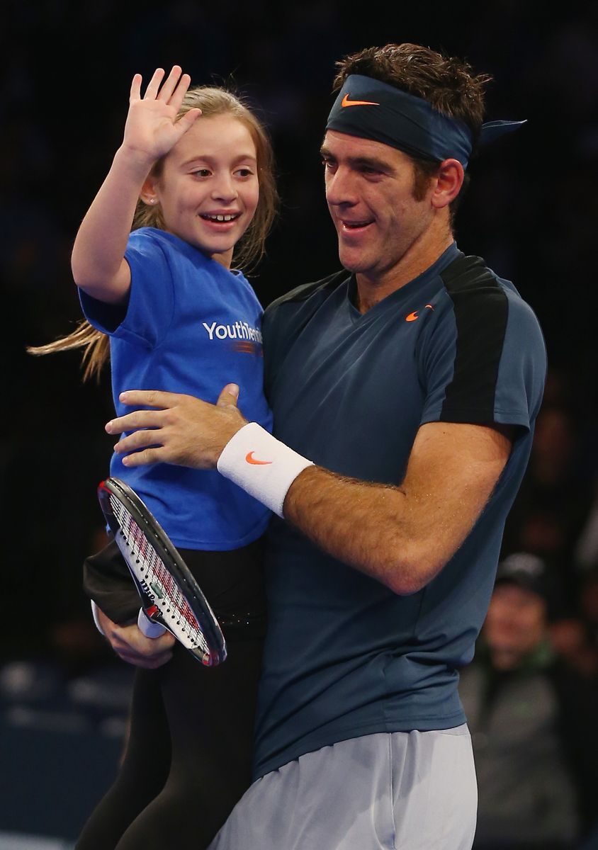 Juan del Potro of Argentina celebrates with the 8-year-old 