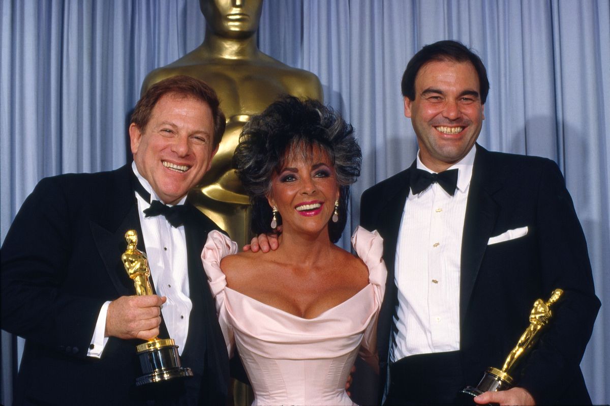 Elizabeth Taylor with Oscar winners Oliver Stone and Arnold Kopelson for "Platoon", the 1987 Best Picture winner