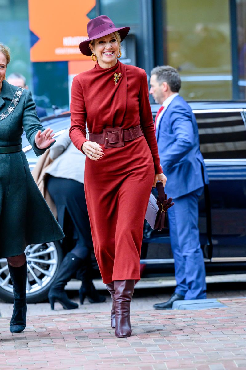 Queen Maxima opted for a rich red paired with a striking purple