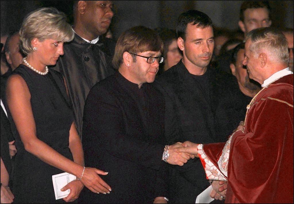 Elton John standing next to Princess Diana during the requiem mass for Gianni Versace, 1997