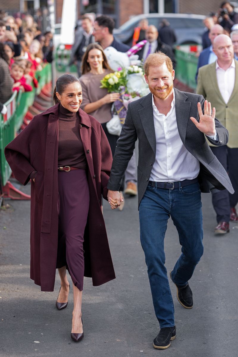 NOTTINGHAM, ENGLAND - OCTOBER 15: Meghan, Duchess of Sussex and Prince Harry, Duke of Sussex greet well-wishers as they arrive at the Community Recording Studio (CRS).