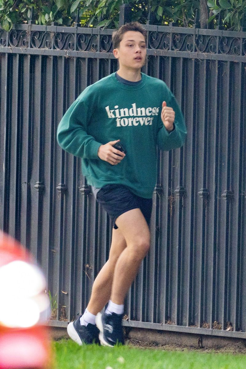 Knox Jolie Pitt on a run in Los Angeles wearing a sweatshirt that reads 'Kindness forever'
