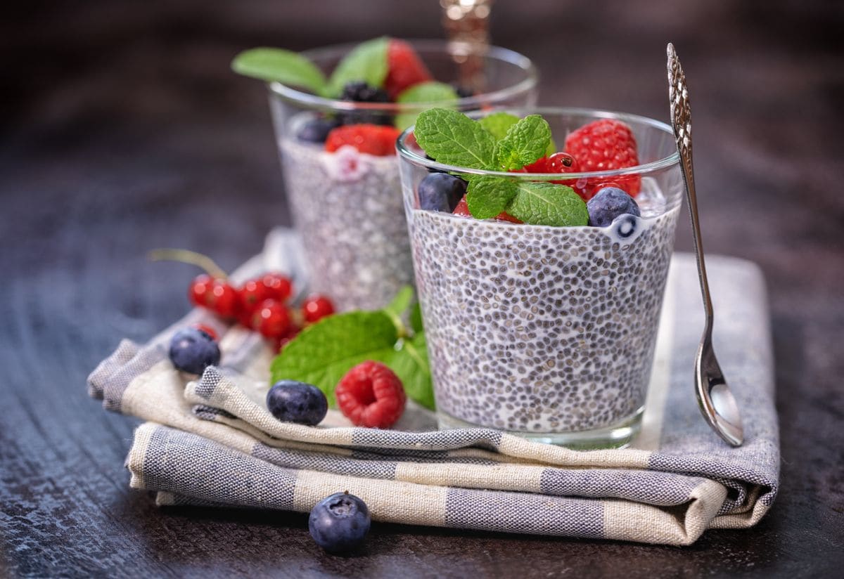 Chia seed pudding with fresh berries and mint topping for breakfast.