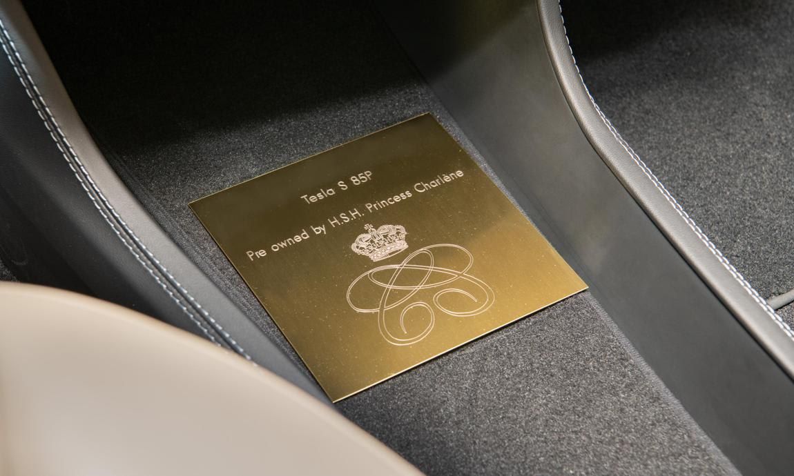 The inside of the automobile features a gold plaque