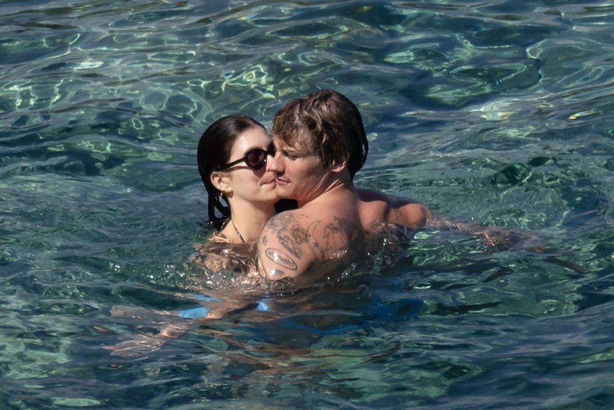 Camila Morrone and Cole Bennett shared kisses and sweet embraces before heading into the water together.