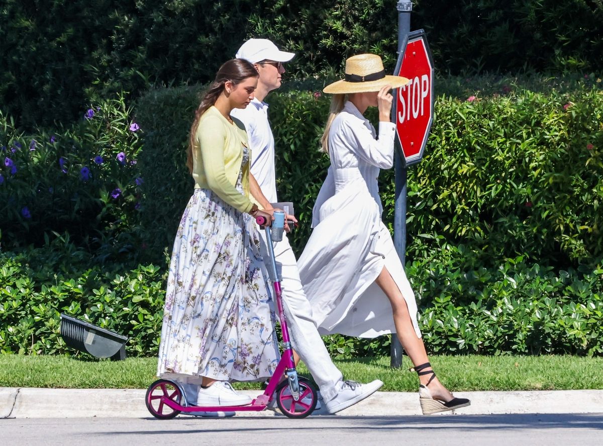 Ivanka opted for a chic white midi shirt dress featuring a fitted waist and front-button detailing, delivering a timeless, understated elegance with a resort-inspired feel. 