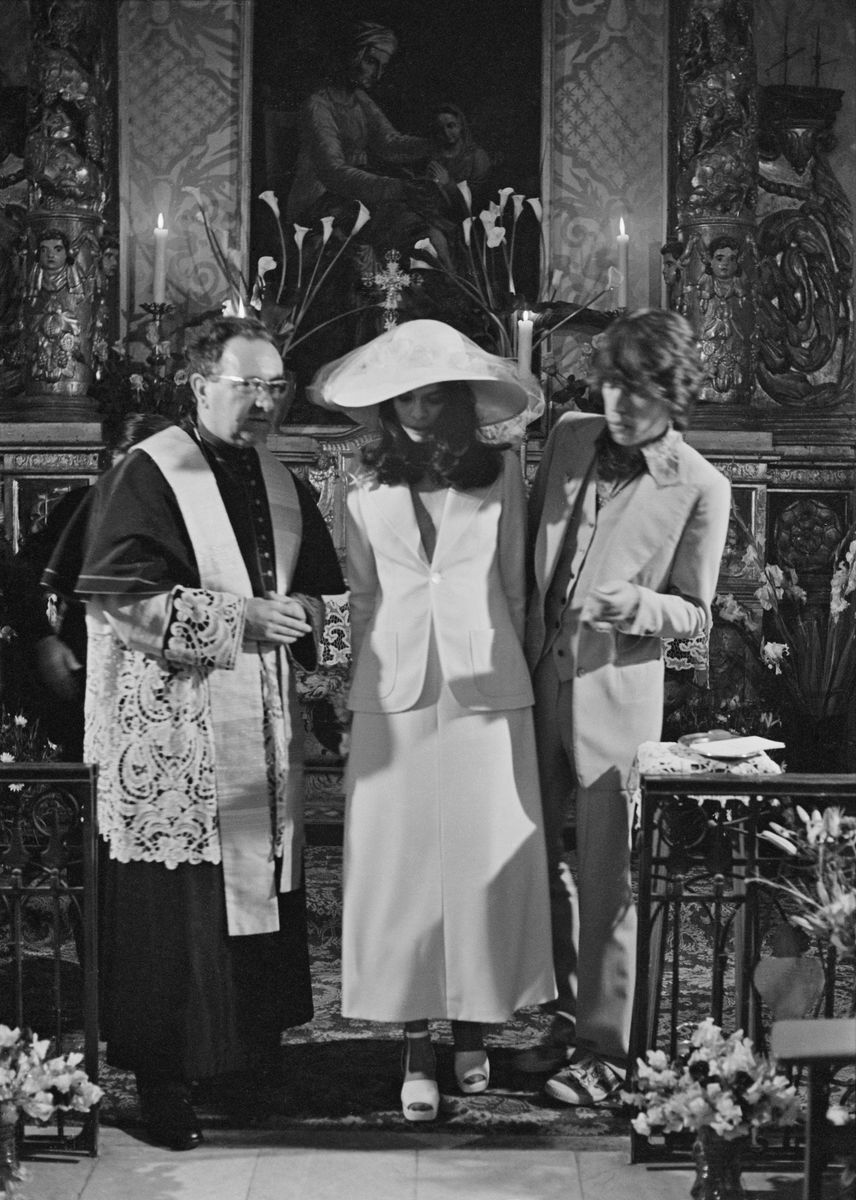 Mick and Bianca Jagger with the officiating priest at their wedding at the Church of St. Anne, St Tropez, 12th May 1971. 