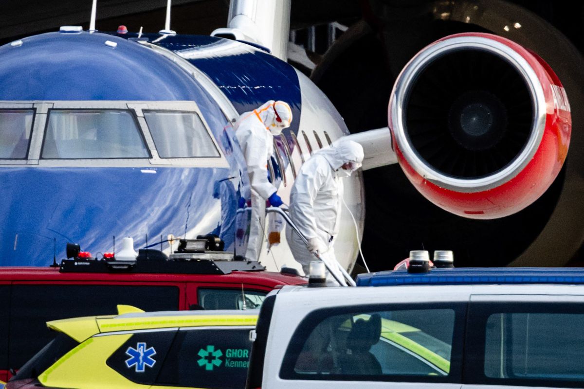 People in hazmat suits descend from a Bombardier Challenger 605 medical plane carrying some of the passengers from the cruise ship MV Hondius, believed to be infected with hantavirus at Schiphol Airport in Amsterdam on May 6, 2026. 