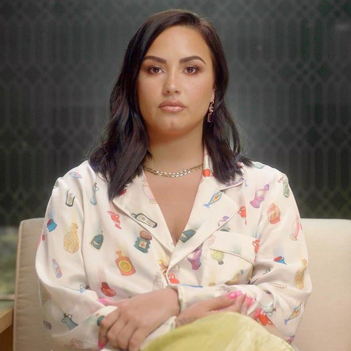 Demi Lovato sitting in a chair.