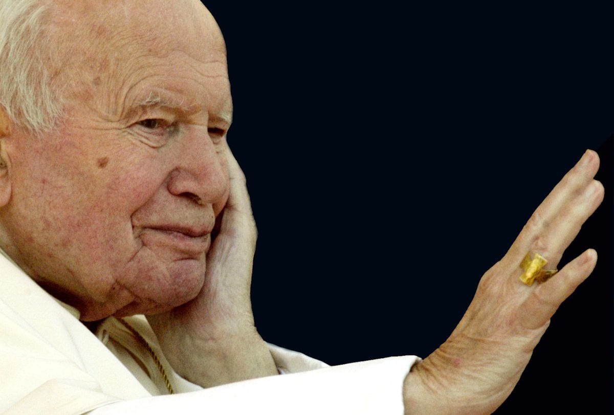 Pope John Paul II waves to the pilgrims and faithful gathered in St. Peter's Square during his weekly general audience March 26, 2003 in Vatican City, Italy.