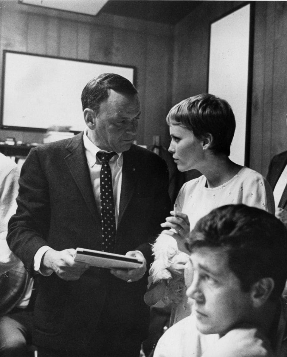 Film actor and popular singer Frank Sinatra chats with his young wife, actress Mia Farrow, during a break in a recording session at Hollywood's Sunset Boulevard recording studio. 