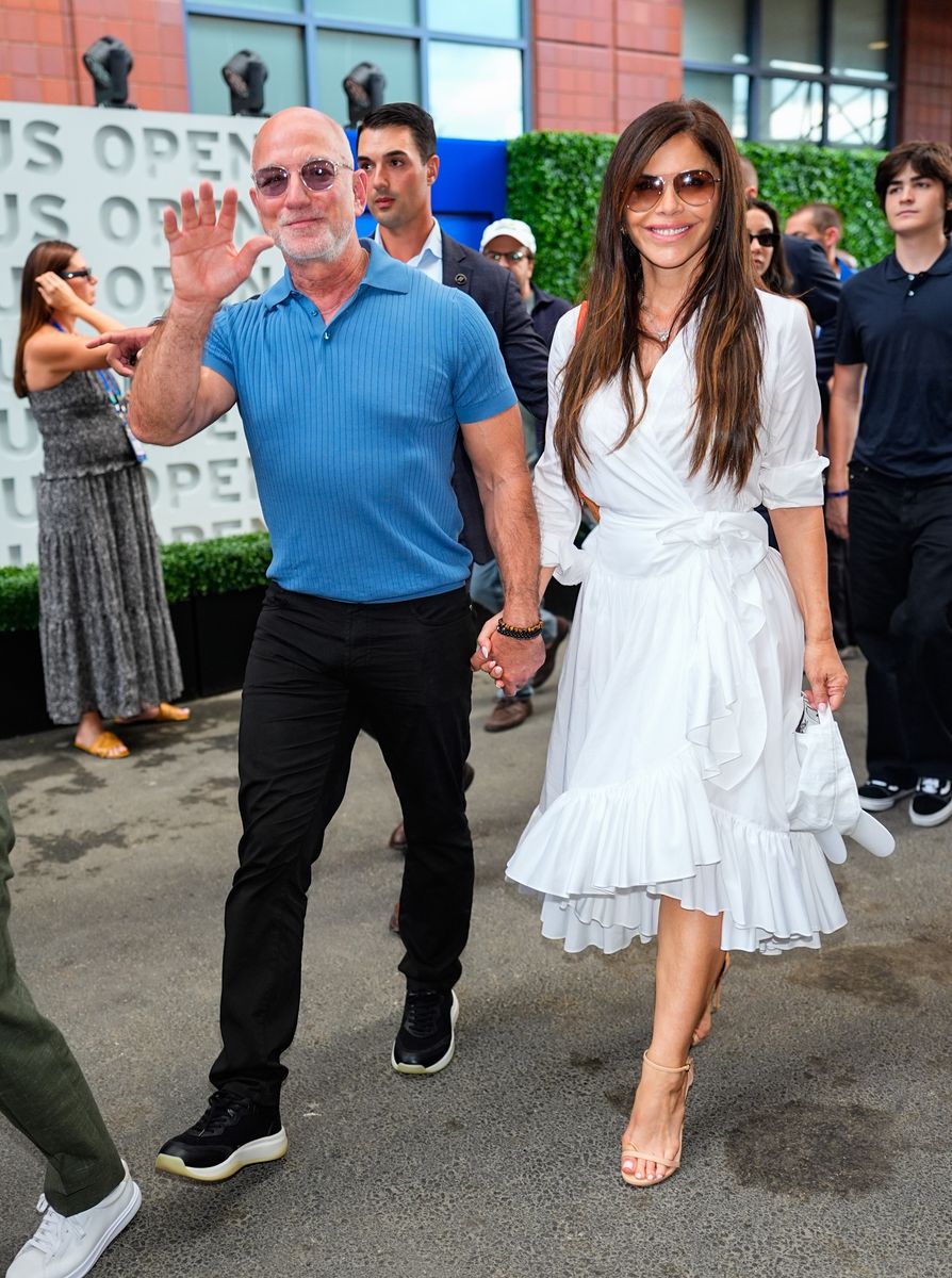 Lauren embraced classic tennis whites in a romantic wrap dress featuring a belted waist and cascading ruffles.