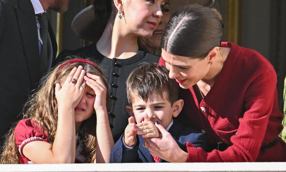 India's rings were on display as she covered her face beside her little cousin Balthazar.