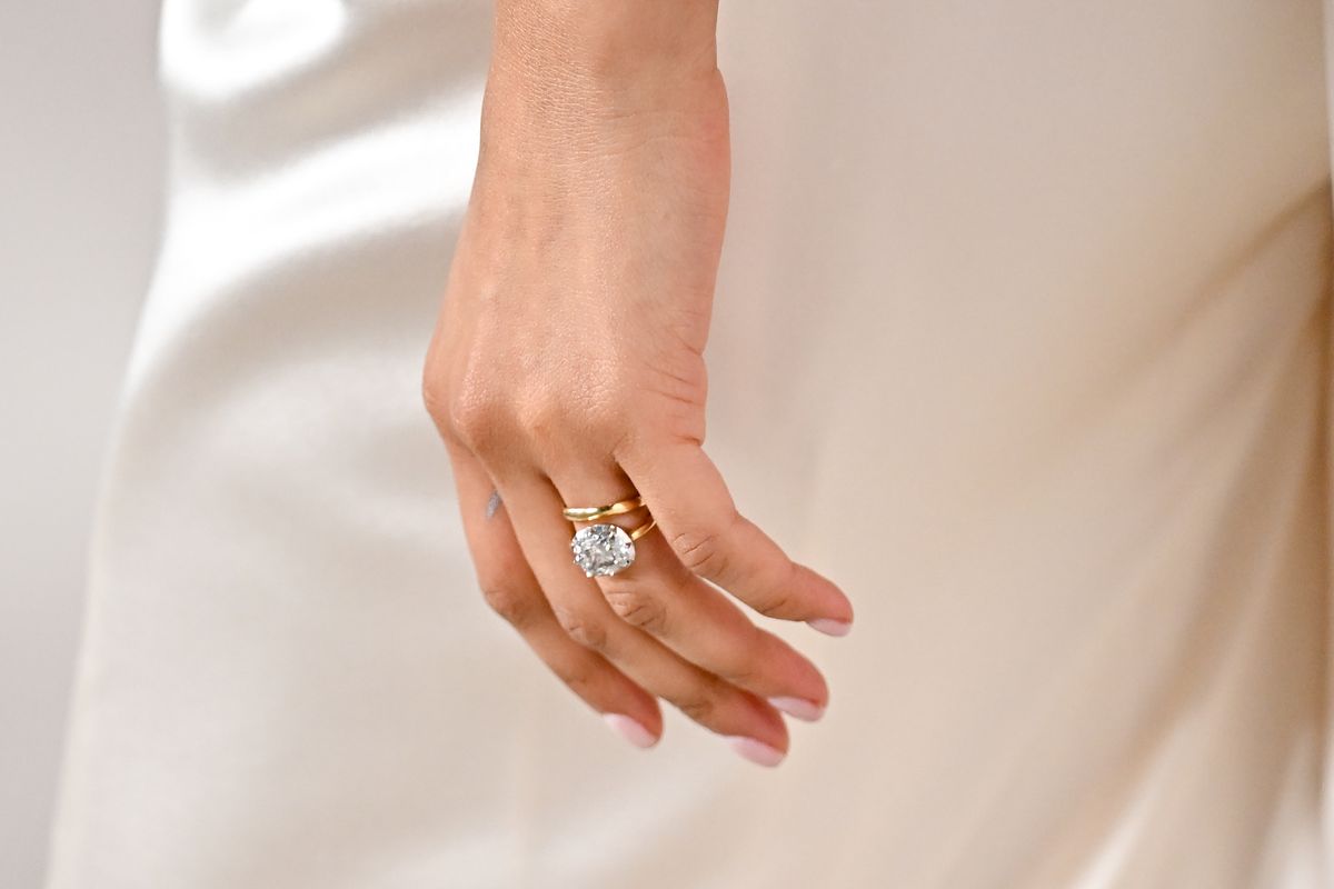 Zendaya paired her dazzling diamond engagement ring with a simple gold band following her secret marriage to Tom Holland.