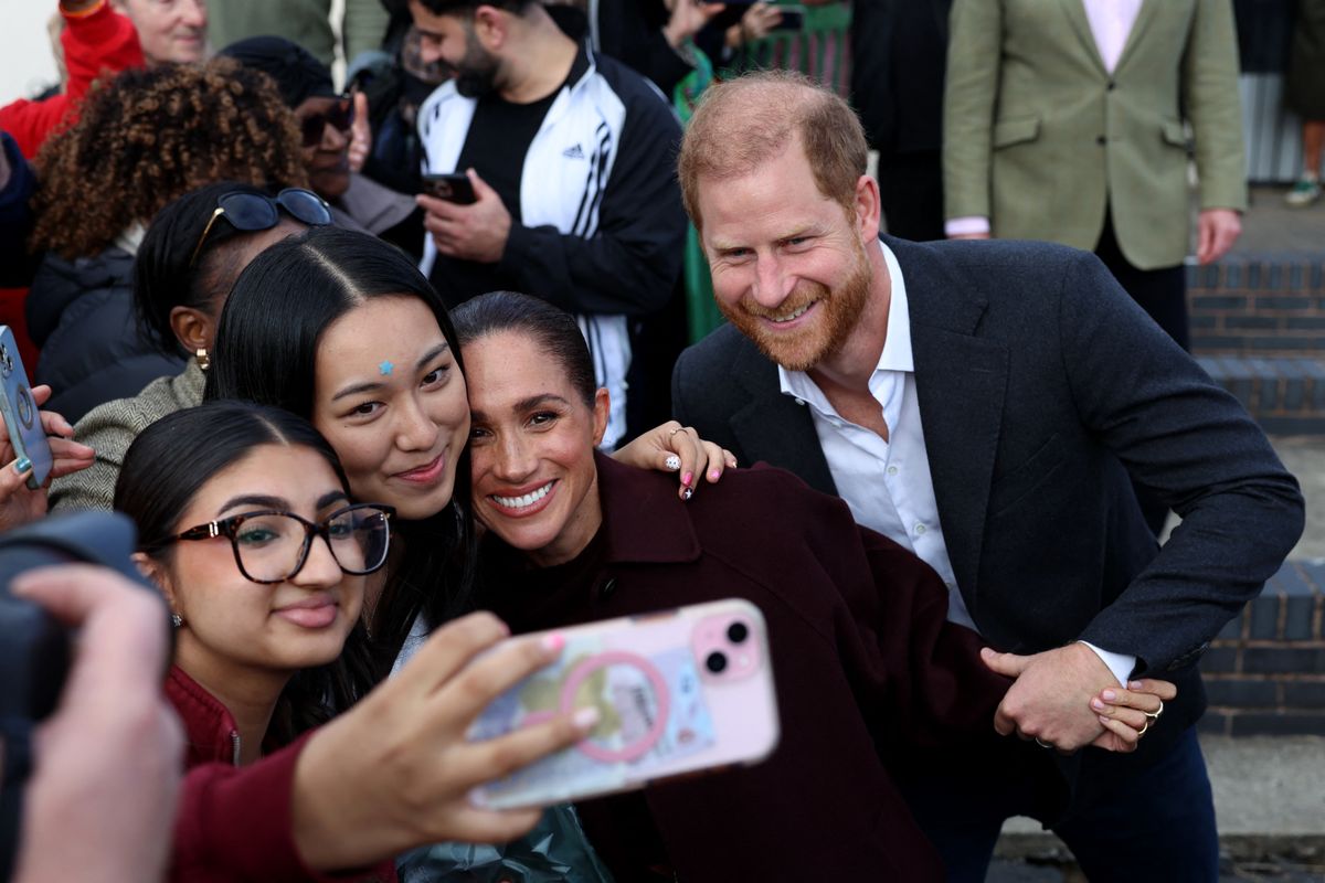 Britain's Prince Harry, Duke of Sussex and his wife Meghan, Duchess of Sussex, greet wellwhishers as they leave after their visit to the Community Recording Studio (CRS)
