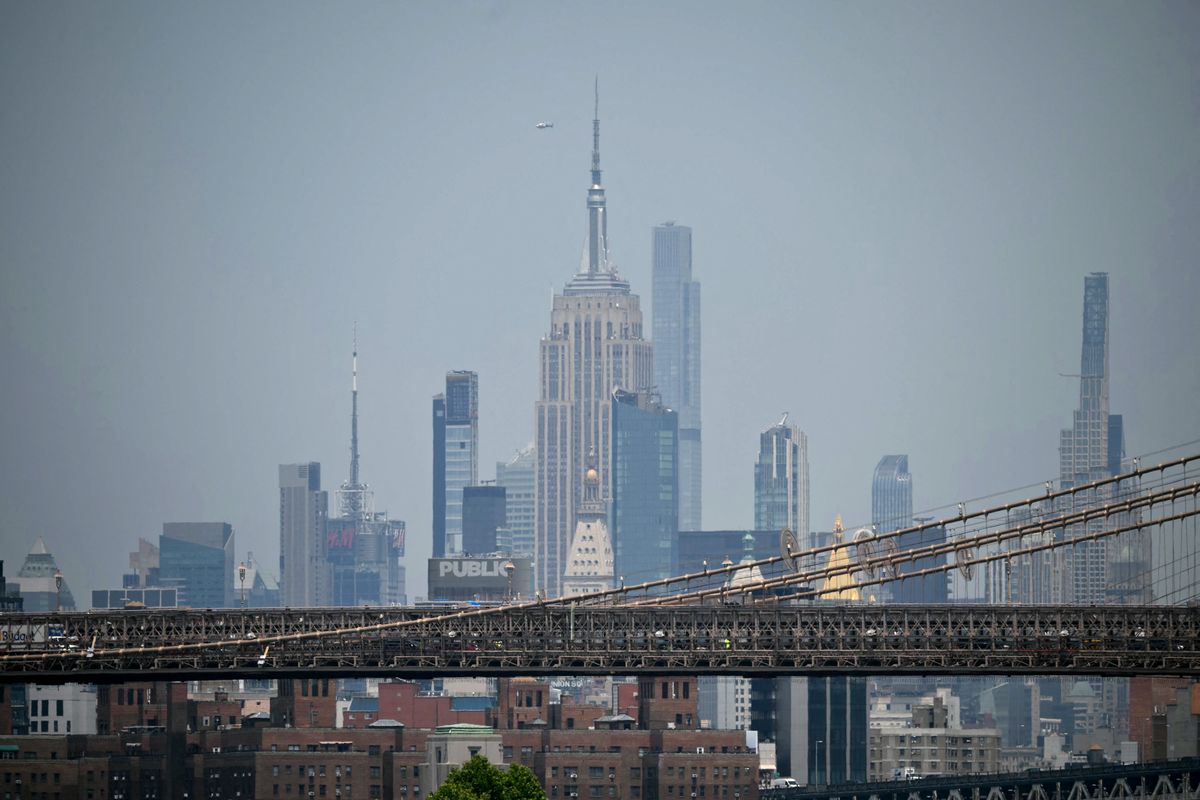 Two people climbed to the top of the Empire State Building on July 1 and unfurled a banner appearing to read "when the power of love beats the love of power the world knows peace," video published by US media showed.