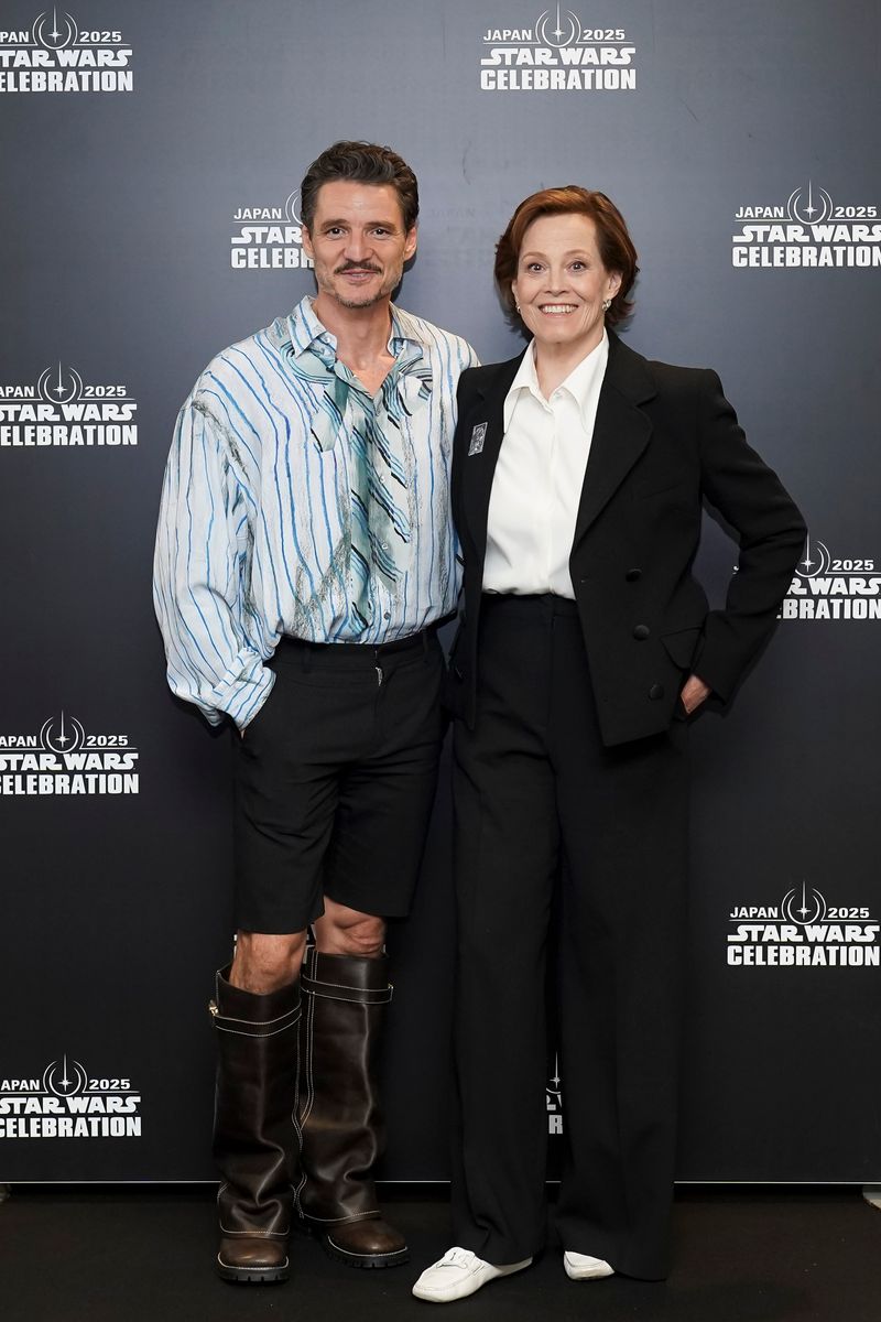 Pedro Pascal and Sigourney Weaver pose for a photo backstage during Star Wars Celebration 