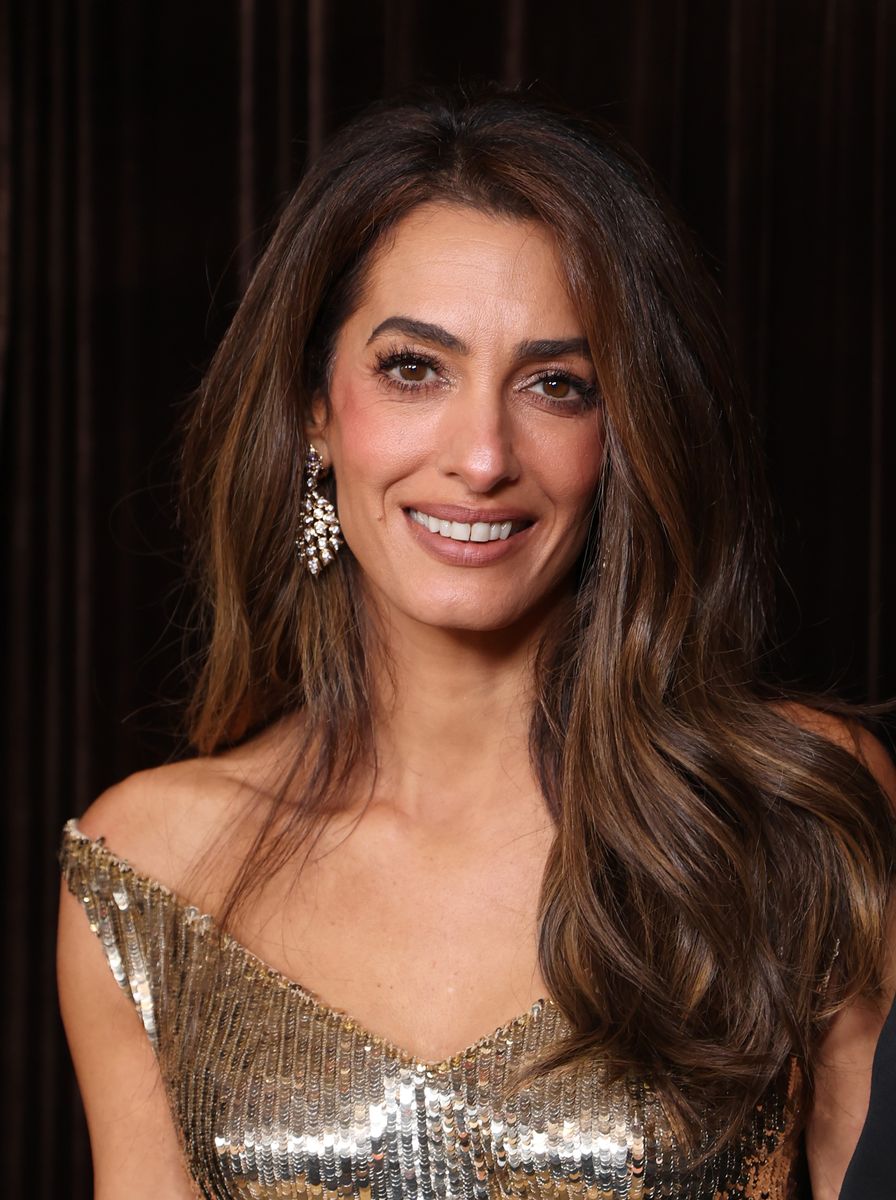 Her highlighted brunette hair complemented the warm tones of her gold gown.