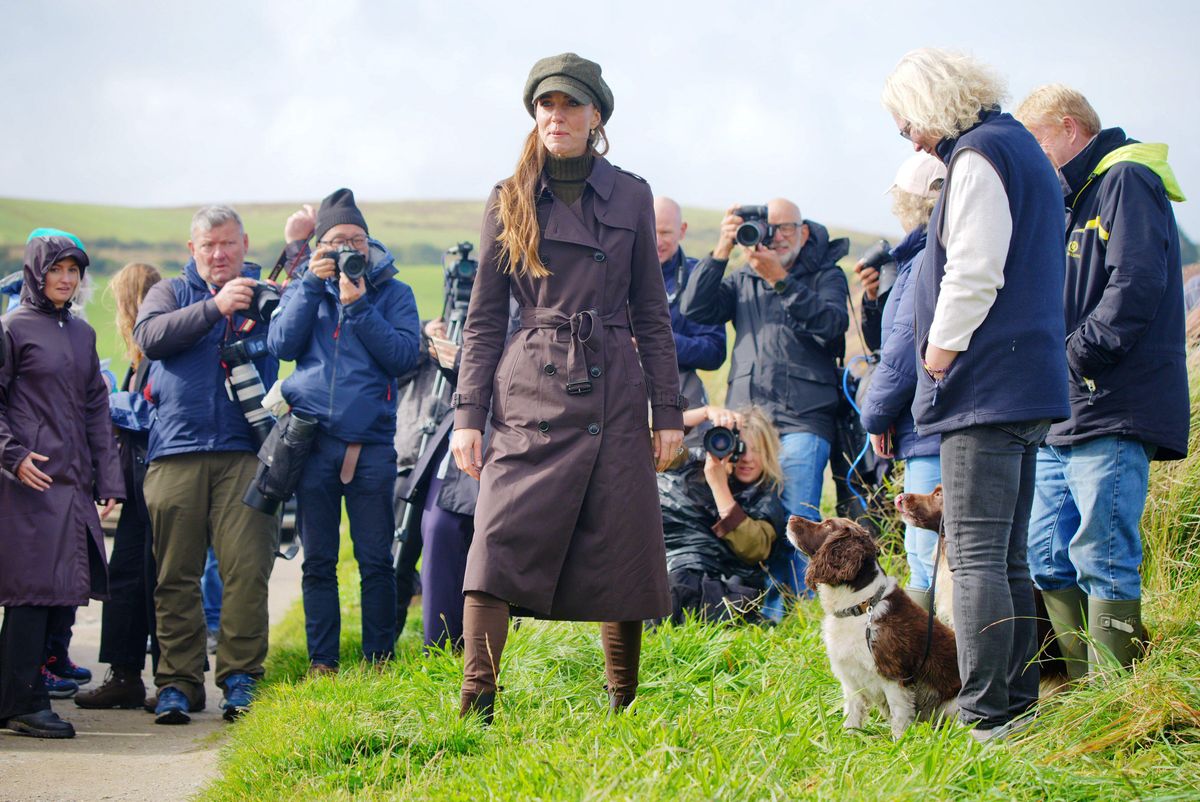 Kate added a newsboy-style cap to her autumnal ensemble as rainy weather swept through the royal couple’s visit to Bute.