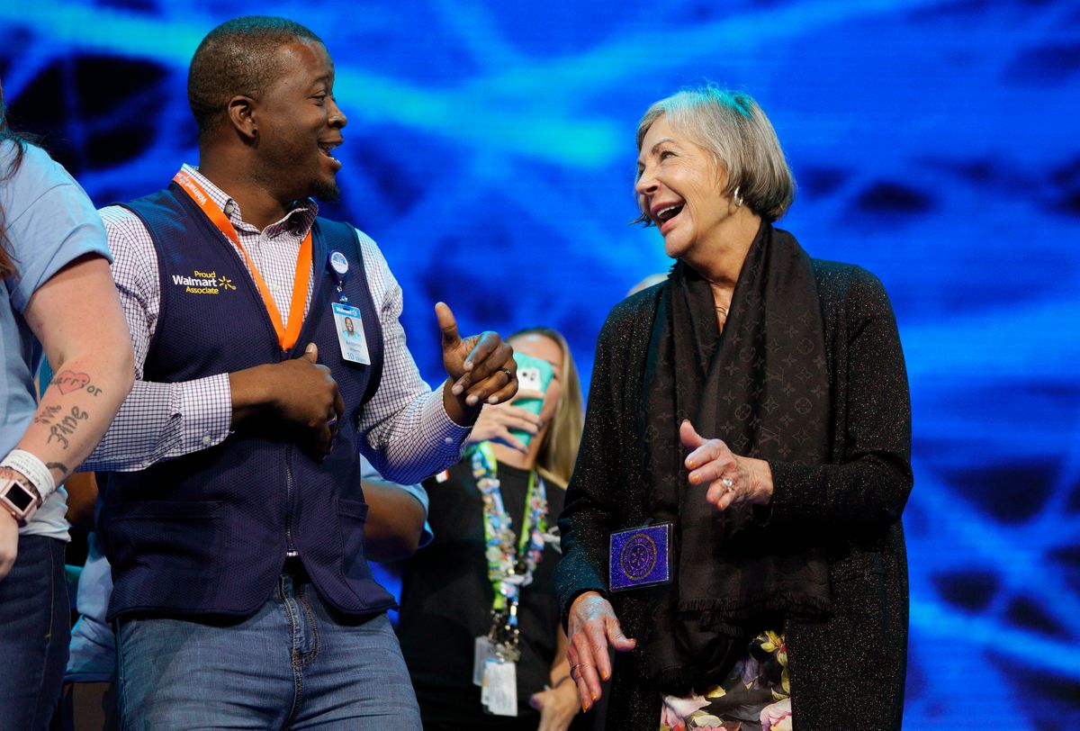  Alice Walton, daughter of Walmart founder Sam Walton, dances with Walmart associate Antonio Williams onstage during the annual shareholders meeting event.