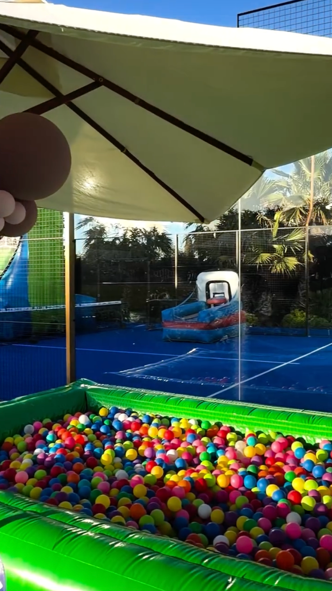 Balloon arches, carnival booths, and vibrant décor turned the family residence into a private amusement park.