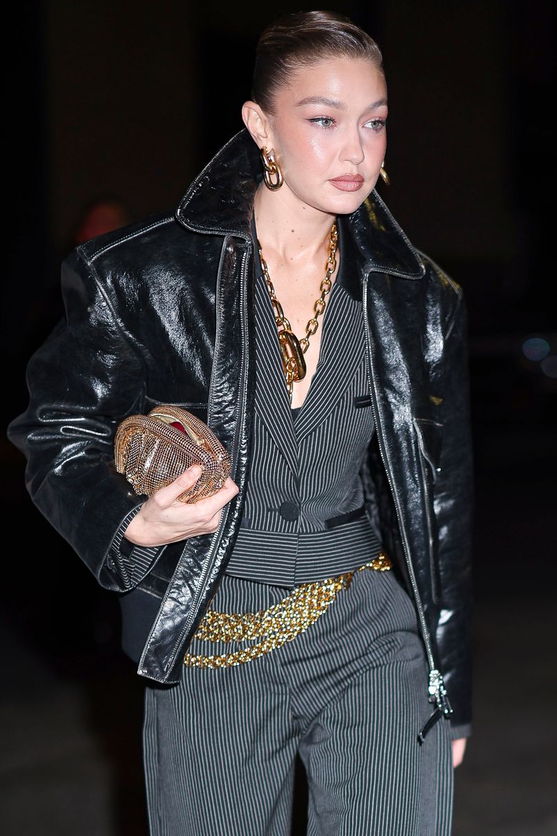 Gigi Hadid seen wearing a chains belt combined with a black jacket.