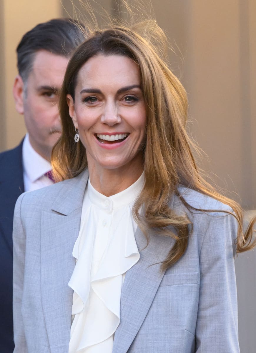 Kate styled the suit with a silk satin ruffle blouse by London-based Knatchbull and a statement lavallière