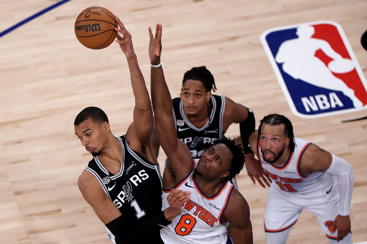 Victor Wembanyama #1 of the San Antonio Spurs and OG Anunoby #8 of the New York Knicks compete for a jump ball during the second quarter in Game Four of the 2026 NBA Finals.