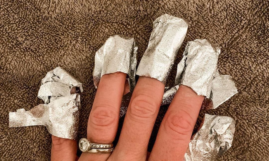 Woman doing nail gel removal