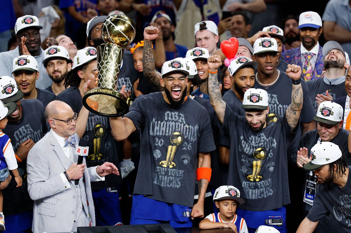 Karl-Anthony Towns #32 of the New York Knicks celebrates with the Larry O'Brien Championship Trophy after the victory against the San Antonio Spurs in Game Five of the 2026 NBA Finals at Frost Bank Center on June 13, 2026 in San Antonio, Texas.